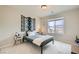 Bright bedroom features a large window, neutral walls, and minimalist decor at 4454 Lantern Point Ave, North Las Vegas, NV 89084