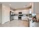 Bright kitchen featuring granite countertops, stainless steel appliances, and white cabinets with ample storage space at 4454 Lantern Point Ave, North Las Vegas, NV 89084