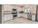 Bright kitchen featuring granite countertops, stainless steel appliances, and white cabinets with ample storage space at 4454 Lantern Point Ave, North Las Vegas, NV 89084