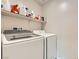 Well-equipped laundry room features a Samsung washer, dryer, and storage shelving at 4454 Lantern Point Ave, North Las Vegas, NV 89084