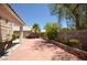 Expansive backyard with paver patio, mature landscaping, and a privacy wall at 10417 Niagara Falls Ln, Las Vegas, NV 89144