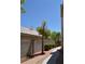 Enclosed backyard with brick-lined walkway and mature landscaping, offering a private retreat at 10417 Niagara Falls Ln, Las Vegas, NV 89144