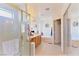 Bright bathroom showcasing a glass enclosed shower, dual sinks, and a soaking tub at 10417 Niagara Falls Ln, Las Vegas, NV 89144