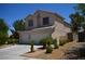 Attractive two-story home with a two-car garage, complemented by landscaping and a walkway leading to the entrance at 10417 Niagara Falls Ln, Las Vegas, NV 89144
