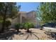 Inviting home exterior with drought-resistant landscaping, mature trees, and a private driveway at 10417 Niagara Falls Ln, Las Vegas, NV 89144
