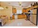 Functional kitchen with wooden cabinets, stainless steel appliances, and tile flooring, designed for everyday convenience at 10417 Niagara Falls Ln, Las Vegas, NV 89144