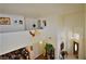 Open loft overlooking living room, adorned with art and flowers, next to front door entrance and hardwood floors at 10417 Niagara Falls Ln, Las Vegas, NV 89144