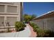 Side yard with walkway, mature bushes, and privacy wall at 10417 Niagara Falls Ln, Las Vegas, NV 89144