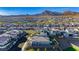 An aerial view captures a residential community with well-maintained homes, mountain views, and neighborhood streets at 11700 Belorado Ave, Las Vegas, NV 89138