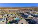Beautiful aerial view of a residential community featuring single-Gathering homes, community pool, and scenic mountain views at 11700 Belorado Ave, Las Vegas, NV 89138