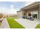 A beautifully landscaped backyard with a putting green and a patio with outdoor seating offers an inviting space for relaxation at 11700 Belorado Ave, Las Vegas, NV 89138