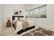 Bright bedroom with a large window, plush rug and throw, featuring a queen-sized bed with a padded headboard at 11700 Belorado Ave, Las Vegas, NV 89138