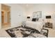 Comfortable bedroom featuring a plush bed, modern artwork, and a view from the large window at 11700 Belorado Ave, Las Vegas, NV 89138