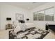 Comfortable bedroom featuring a plush bed, modern artwork, and a view from the large window at 11700 Belorado Ave, Las Vegas, NV 89138