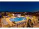 Community pool and lounge area with city views at night at 11700 Belorado Ave, Las Vegas, NV 89138