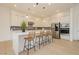 A bright and modern kitchen area featuring a center island, stainless steel appliances, and custom lighting at 11700 Belorado Ave, Las Vegas, NV 89138