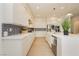 A bright kitchen with white cabinets, stainless appliances, and a patterned backsplash at 11700 Belorado Ave, Las Vegas, NV 89138