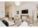 A living room area featuring a white sofa, plush pillows, a modern glass table, and an entertainment center at 11700 Belorado Ave, Las Vegas, NV 89138