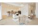 An open floor plan living room area flows into a kitchen with hardwood floors, recessed lighting, and white walls at 11700 Belorado Ave, Las Vegas, NV 89138