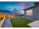 A putting green in a landscaped backyard provides a dedicated space for golf enthusiasts to practice and enjoy the outdoors at 11700 Belorado Ave, Las Vegas, NV 89138