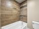 Bathroom featuring modern wood-look tile walls around a white soaking tub at 1405 Vegas Valley Dr # 226, Las Vegas, NV 89169