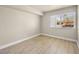 Bright bedroom features large window with views, wood-look flooring, and neutral walls at 1405 Vegas Valley Dr # 226, Las Vegas, NV 89169