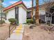 Condo building with stucco walls, red tile roof, brown trim and desert landscaping, leading to the front door at 1405 Vegas Valley Dr # 226, Las Vegas, NV 89169