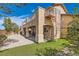 Home's backyard featuring a covered patio, spiral staircase, and desert landscaping at 1684 Flores Ln, Henderson, NV 89012