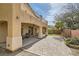 Backyard featuring a covered patio, spiral staircase, and desert landscaping at 1684 Flores Ln, Henderson, NV 89012