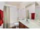 Clean bathroom with shower and tub combination and large vanity area at 1684 Flores Ln, Henderson, NV 89012