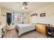 Cozy bedroom with natural light, ceiling fan, and warm-toned carpet at 1684 Flores Ln, Henderson, NV 89012