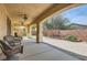 Spacious covered patio with ceiling fans, brick border, and backyard access at 1684 Flores Ln, Henderson, NV 89012