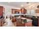 Well-equipped kitchen featuring dark countertops, wooden cabinets, and stainless steel appliances at 1684 Flores Ln, Henderson, NV 89012