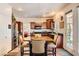 Cozy eat-in kitchen features stainless steel appliances, dark wood cabinets and countertops and a view to the backyard at 1684 Flores Ln, Henderson, NV 89012
