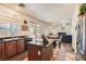 Modern kitchen featuring dark countertops, stainless steel appliances, and wood cabinetry at 1684 Flores Ln, Henderson, NV 89012