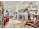 Open living room featuring tile flooring, a staircase, and several custom bookshelves at 1684 Flores Ln, Henderson, NV 89012