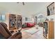 Spacious living room featuring a high ceiling, tile floors, and custom built-in bookshelves at 1684 Flores Ln, Henderson, NV 89012