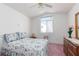 Cozy bedroom with bright natural light, ceiling fan, and floral bedding at 1813 Villa Vista Way, Las Vegas, NV 89128