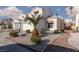Well-maintained home exterior features desert landscaping, mature palms, and a two-car garage at 1813 Villa Vista Way, Las Vegas, NV 89128
