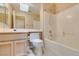 Clean bathroom featuring a shower-tub combo, toilet and vanity with storage at 2175 Point Mallard Dr, Henderson, NV 89012
