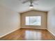 Spacious bedroom features a ceiling fan, hardwood floors, and a large window at 2175 Point Mallard Dr, Henderson, NV 89012