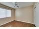 Bedroom with hardwood flooring, white ceiling fan, and a bright window at 2175 Point Mallard Dr, Henderson, NV 89012