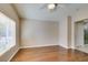 Large bedroom with hardwood floors, ceiling fan, and natural light at 2175 Point Mallard Dr, Henderson, NV 89012