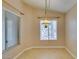 Dining room with tile flooring, a window with blinds, and hanging light fixture at 2175 Point Mallard Dr, Henderson, NV 89012