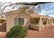 Exterior of house with a covered patio, desert landscaping, and neutral paint at 2175 Point Mallard Dr, Henderson, NV 89012