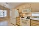 Bright kitchen features white appliances, beige cabinetry, and granite countertops at 2175 Point Mallard Dr, Henderson, NV 89012