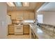 Bright kitchen with gas range and granite countertops seamlessly connects to the dining area at 2175 Point Mallard Dr, Henderson, NV 89012