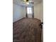 Spacious bedroom featuring neutral carpet, a ceiling fan, and bright natural light from the window at 2232 Aspen Mirror Way # 204, Laughlin, NV 89029