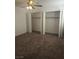 Bedroom featuring neutral walls, carpet, window and spacious closets at 2232 Aspen Mirror Way # 204, Laughlin, NV 89029