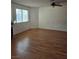 A view of an empty living room featuring laminate flooring, a ceiling fan, and a fireplace at 2232 Aspen Mirror Way # 204, Laughlin, NV 89029